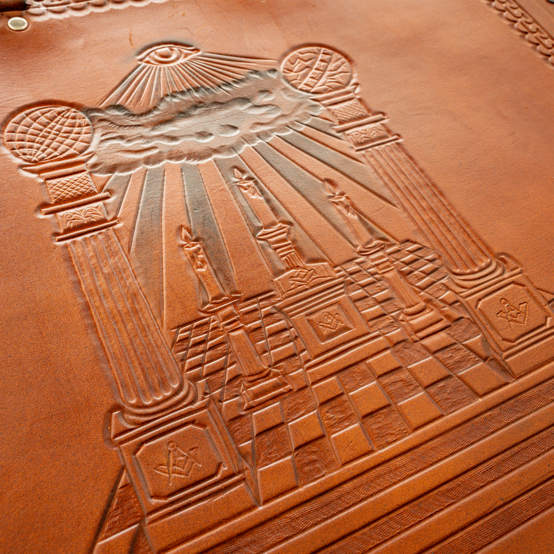 Hand-tooled brown leather Masonic apron case with Boaz & Jachin Columns, three candles, Masonic altar, and all-seeing-eye
