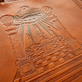 Hand-tooled leather artwork featuring Boaz and Jachin, Masonic altar and Mosaic Pavement, and three candles